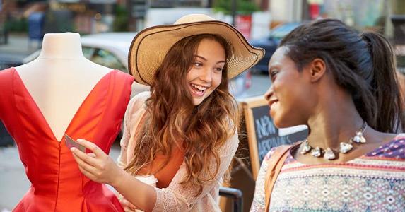 Survey: Americans losing battle between savings, debt Girlfriends shopping for a dress | David Shopper/Getty Images