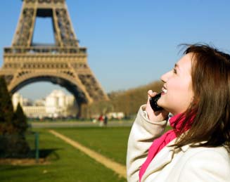 Smiling woman standing across The Eiffel Tower