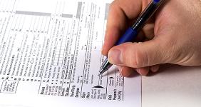 Signing tax form © Mehmet Dilsiz - Fotolia.com
