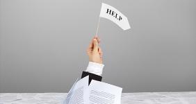 Hand waving white flag for help
