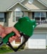Hand holding green gas pump.