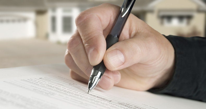 Anxious about the mortgage process? Start here Hand signing contract © iStock
