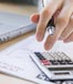 hand with calculator computer