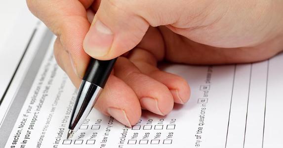Hand with pen over blank checkboxes in a form © Dmitry Naumov/Shutterstock.com