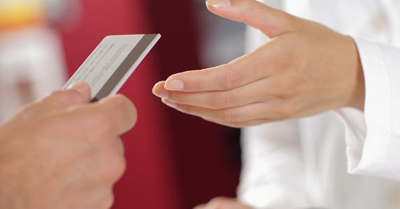 Handing over medical card © Stokkete /Shutterstock.com
