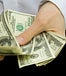 Male hands counting out multiple $100 bills