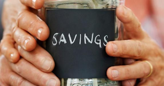 hands of couple holding savings jar