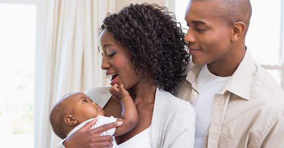Happy young parents smiling at baby © wavebreakmedia/Shutterstock.com