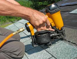 hidden-insurance-credits-4-roof-lg Construction worker stapling new shingles