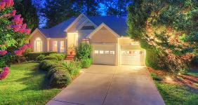 House exterior with lights on at nighttime  © SeanPavonePhoto/Shutterstock.com