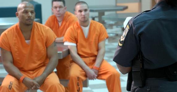 Inmates are often locked out of life insurance Inmates listening to correctional officer | Thinkstock/Getty Images