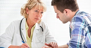 Doctor consoling patient © Alexander Raths/Shutterstock.com