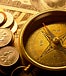 Compass laying on paper money and change