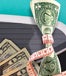 Measuring tape wrapped around money, next to scale