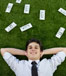 Lying on grass with money