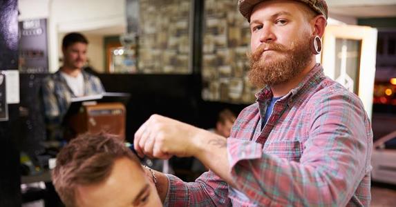 Male barber giving client a haircut | Monkey Business Images/Shutterstock.com