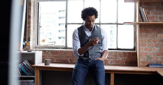 7 ways to pay your tax bill online Man leaning on desk, looking at phone | Lilly Roadstones/Getty Images