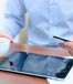 man holding credit card using tablet pc