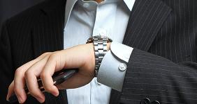 Man checking watch for time © cozyta/Shutterstock.com