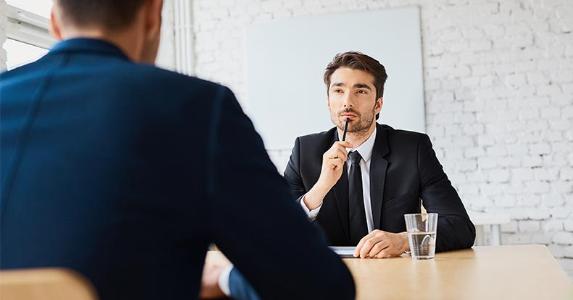 Job hunting could help cut taxes Man in suit, thinking during an interview | baranq/Shutterstock.com