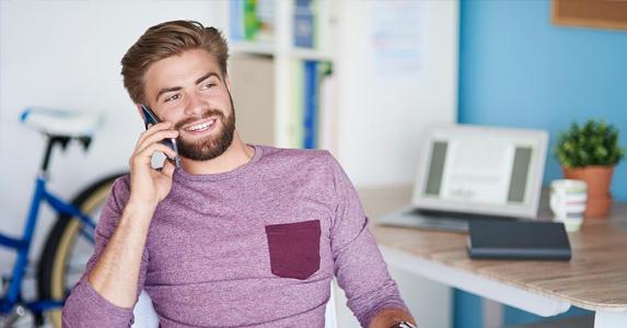 What are the Roth IRA rules? Young man in purple shirt on a phone call | gpointstudio/Getty Images