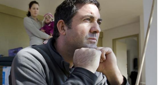 Man thinking on steps of home © ChameleonsEye/Shutterstock.com