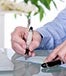 man signing check computer