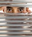 Man looking through blinds