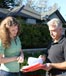 man and woman outside going over paperwork