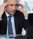 man worried looking at computer