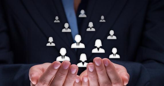 Employee icons floating in cupped hands © Jirsak/Shutterstock.com