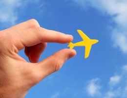 Hand holding a toy plane