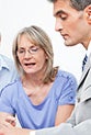 Mature couple with advisor reviewing documents © Robert Kneschke/Shutterstock.com