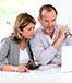 mature couple with calculator computer
