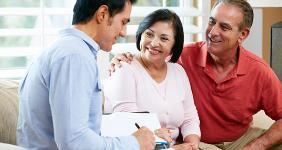 Mature Hispanic American couple with young financial adviser © Monkey Business Images/Shutterstock.com