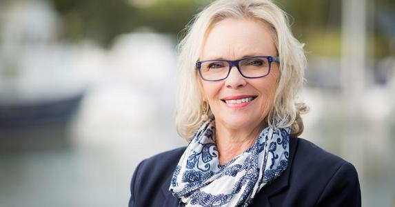 Will my Social Security benefits get cut if I work? Mature professional woman in blue jacket | iStock.com/heebyj