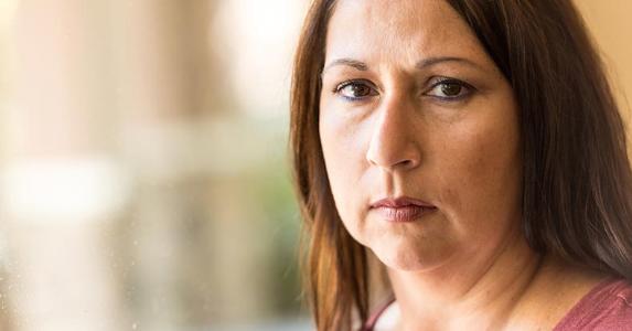 Who has dibs on brother-in-law's life insurance? Woman looking directly at camera with serious expression | Juanmonino/E+/Getty Images