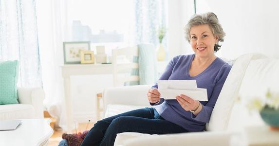 W-2 seems wrong. Does my employer owe me money? Mature woman holding bills | Tetra Images/Getty Images
