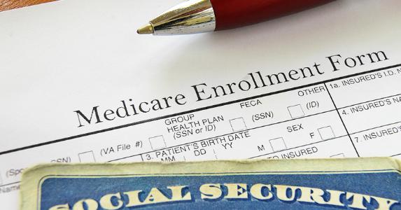 Medicare enrollment form and Social Security card © iStock