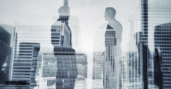 Men standing in office, talking © iStock