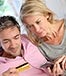 middle-aged couple holding credit card cellphone