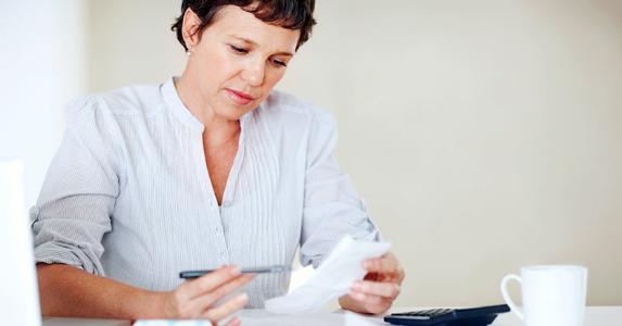 Middle-aged woman going through receipts © iStock