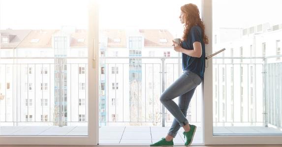 Nearly half of renters covet homeownership Millennial standing in frame of patio doorway | Westend61/Getty Images