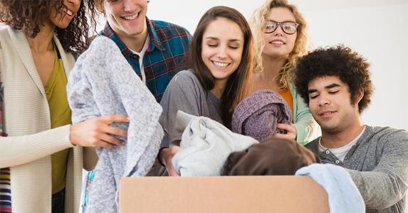 Tax valuation guide for donated goods Millennials dropping off clothes to a donation outbox | JGI/Jamie Grill/Getty Images