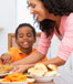 Mom serving dinner to children
