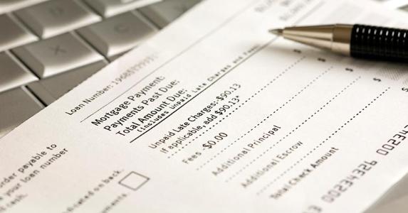 Bottleneck in processing mortgage payments Mortgage loan statement and pen © iStock