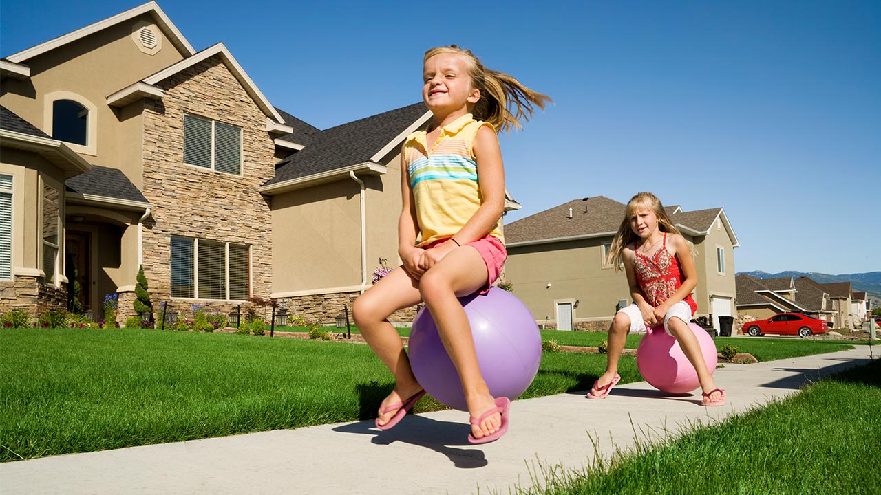 Mortgage rates remain at attractive, 7-month lows Kids playing on large bouncy ball in front of their house | jhorrocks/Getty Images