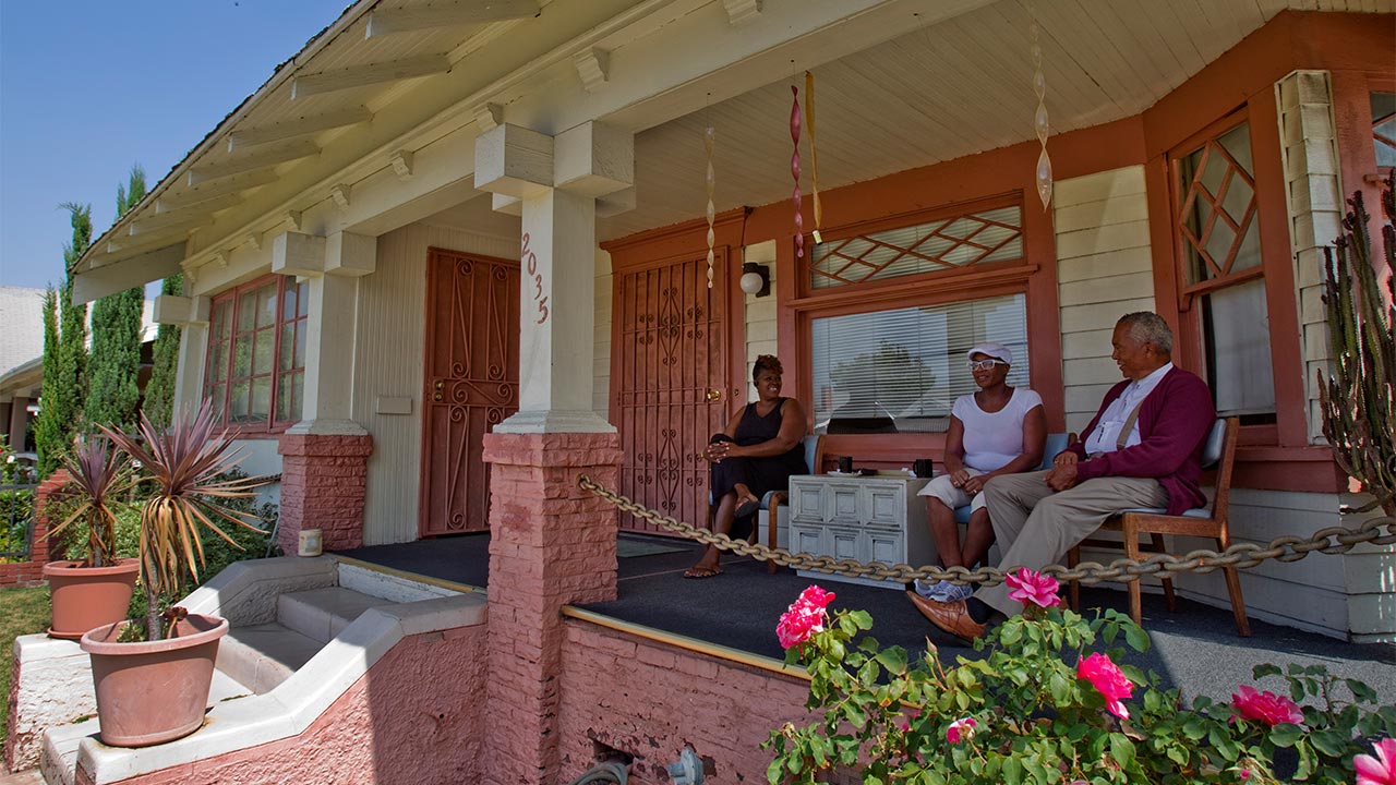 Wake up, it’s refi time: Mortgage rates hit 7-month low Family sitting on patio outside home | Allen J. Schaben/Getty Images
