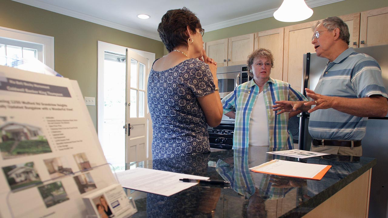 Mortgage rates rise, but finding a home is the bigger challenge Three people being shown an open house | Jay Laprete/Bloomberg via Getty Images