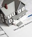 Toy house on mortgage documents